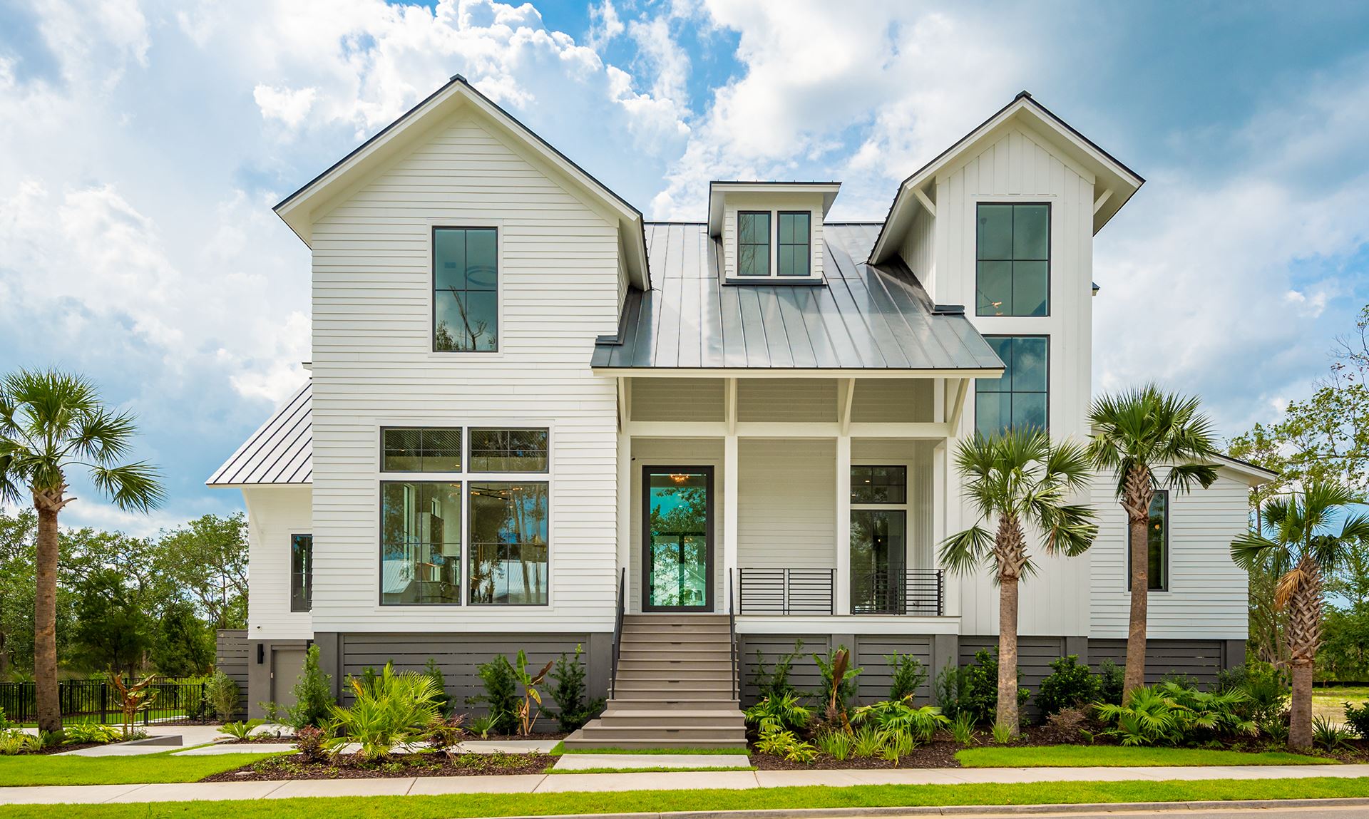 Front elevation of a coastal, custom home with Savannah Smooth and palm trees